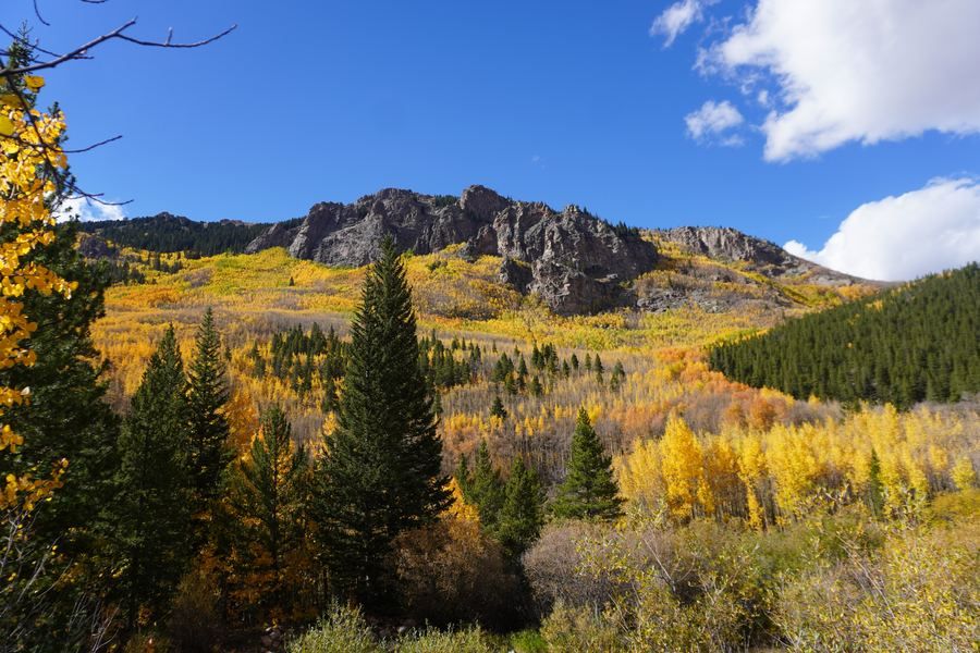 Craggy ridge above a valley of gold and green